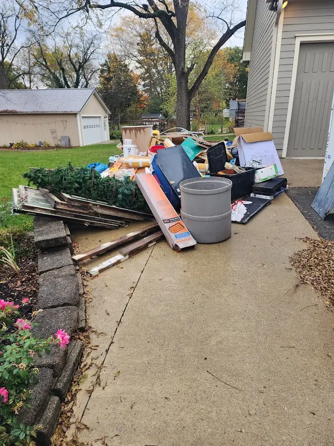 Dumpster being loaded with debris for 10 Yard Dumpster Rental in Elk Plain